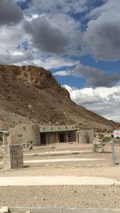 Exterior of a small lodging building at the base of a rocky hill in Big Bend National Park.