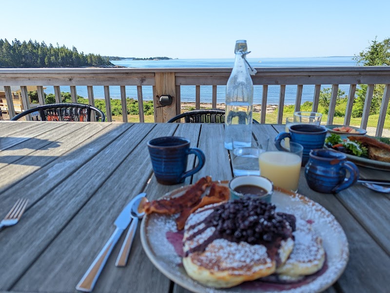 Goose Cove breakfast on a wooden deck with ocean views in Acadia National Park.