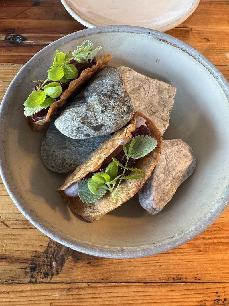 Goose Cove seafood dish plated in a stone bowl with fresh herbs, photographed in Acadia National Park.