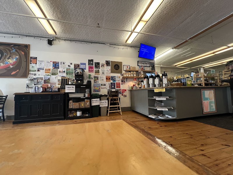 Interior view of Flexit Cafe at Acadia National Park, showing a service counter, bulletin wall, and display shelves.