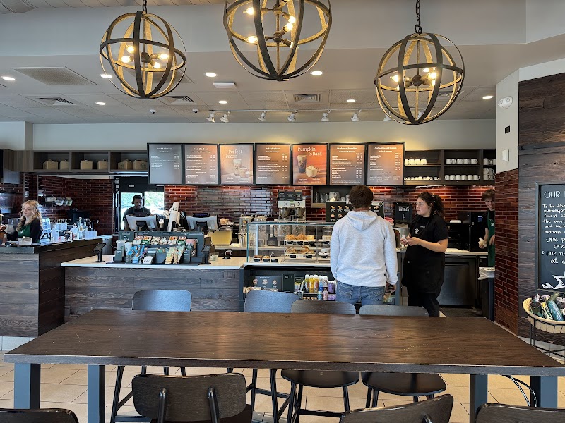 Coffee shop interior with long wooden table and pendant lights in Glacier National Park gateway area