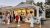 Dairy bar kiosk in Acadia National Park draws a line of visitors at a seaside stand with menus fluttering and warm evening light.