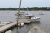 Milbridge harbor at Acadia National Park shows fishing boats docked along a wooden pier.