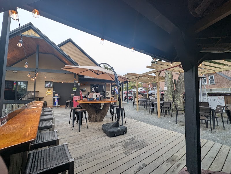 Outdoor seating area at a tavern in Acadia National Park, with string lights and wooden deck.