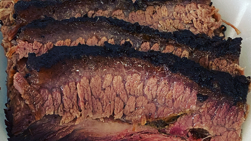 Smoked beef ribs served at a Big Bend National Park restaurant, showing dark bark and a pink smoke ring.