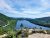 Overlook from North Bubble Trailhead in Acadia National Park, a blue lake framed by forested hills and rocky ledges.