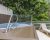 Above-ground pool on a wooden deck with a metal handrail, and a beige lounge chair in Acadia National Park.
