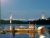 Bucksport waterfront at dusk with the illuminated Penobscot Narrows Bridge spanning the river near Acadia National Park.