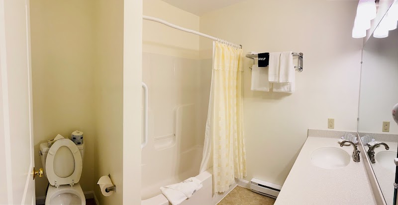 Guest bathroom in lodging unit near Acadia National Park, showcasing a standard motel-style setup.