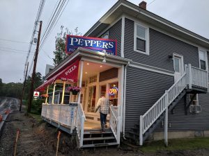 Cold, overcast morning at a two-story coffee shop storefront along a road in Acadia National Park.
