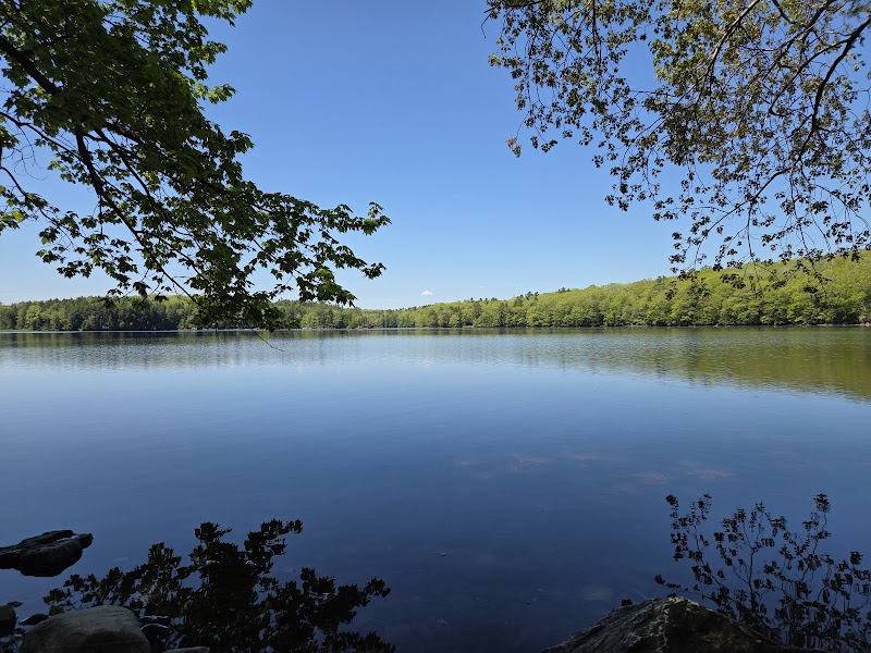 Dead River Trailhead at Great Pond Mountain Wildlands, Acadia National Park, overlooking a tranquil lake with forested shores.