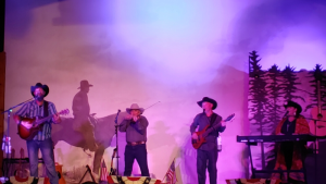 Live country band performs on stage at a Yellowstone National Park restaurant venue.