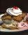 Golden waffle stacks with ice cream, whipped cream, a cherry, and chocolate drizzle on a plate at Arches National Park.