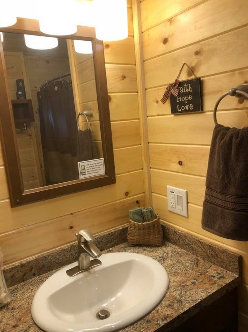Rustic cabin bathroom sink with granite countertop inside a woodland campground near Acadia National Park.