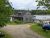 Brooksville waterfront cottage along Acadia National Park's rocky shore, with a wooden dock and a small boat nearby.