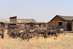 Cody area wagons and log cabins near Yellowstone National Park, showcasing rustic frontier buildings and era wagons.