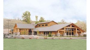 Rustic lodge-style lodging in Cody, Wyoming near Yellowstone National Park, featuring stone pillars and timber beams.