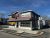 Corner restaurant building in Bar Harbor with red siding and large display windows near Acadia National Park.