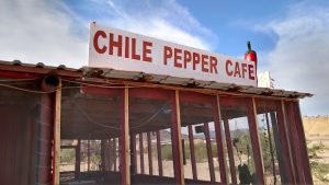 Chili Pepper Cafe exterior with a red sign in a desert landscape at Big Bend National Park