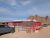 Red-walled cafe building beside a dusty road in Big Bend National Park with rugged mountains in the background.