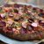 Beet and radish-topped pizza with herbs on a rustic crust, served near Ellsworth, Maine, gateway to Acadia National Park.