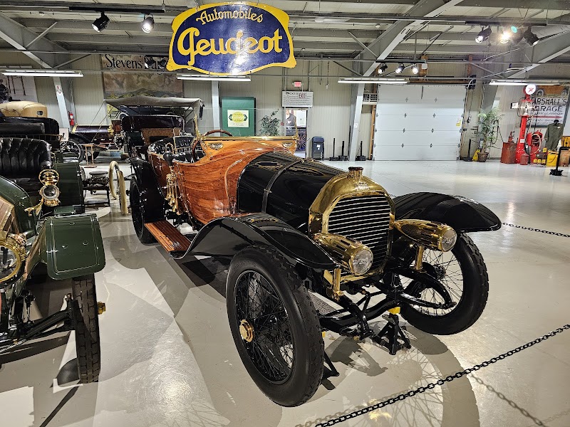 Classic brass-era automobile on display inside a museum near Acadia National Park.