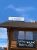 A wooden lodge building with a pub and grill sign in Yellowstone National Park against a clear blue sky.