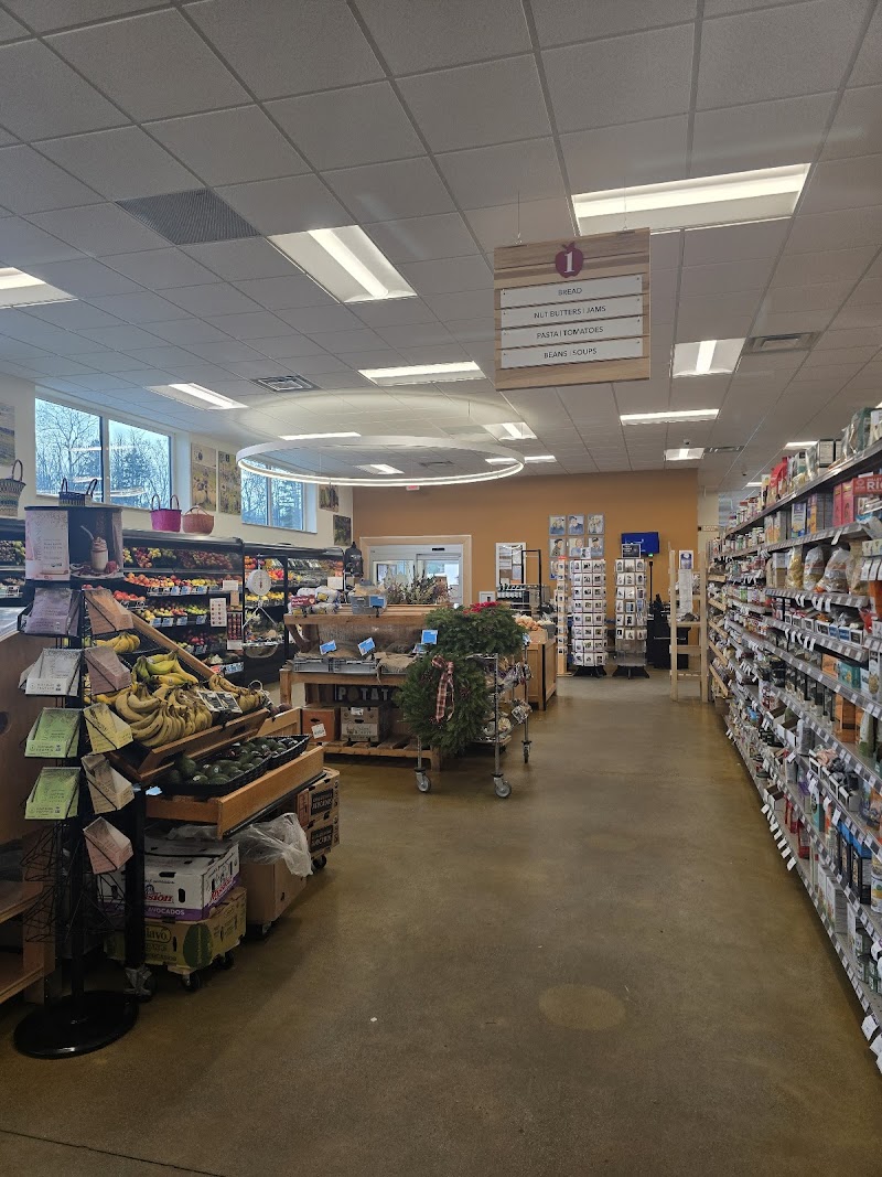 Inside a community co-op grocery in Acadia National Park, showing aisles of snacks, produce, and a checkout area.