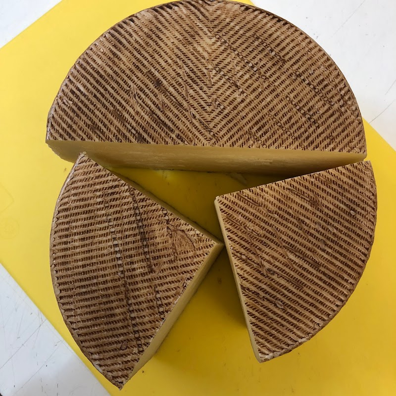 Cheese wheel display at an Acadia National Park restaurant showcases local dairy products.