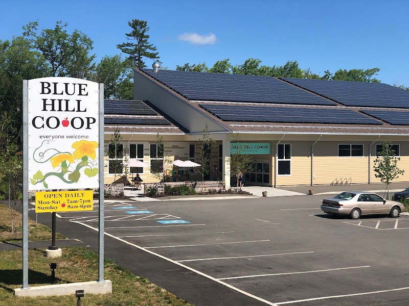 Co-op storefront near Acadia National Park, with solar panels and a small parking lot.