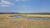 Gibbon River winds through a golden meadow in Yellowstone National Park, with a calm reflective pool nearby.
