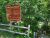 Sign at Echo Lake Beach in Acadia National Park, surrounded by dense green trees and a wooden railing.