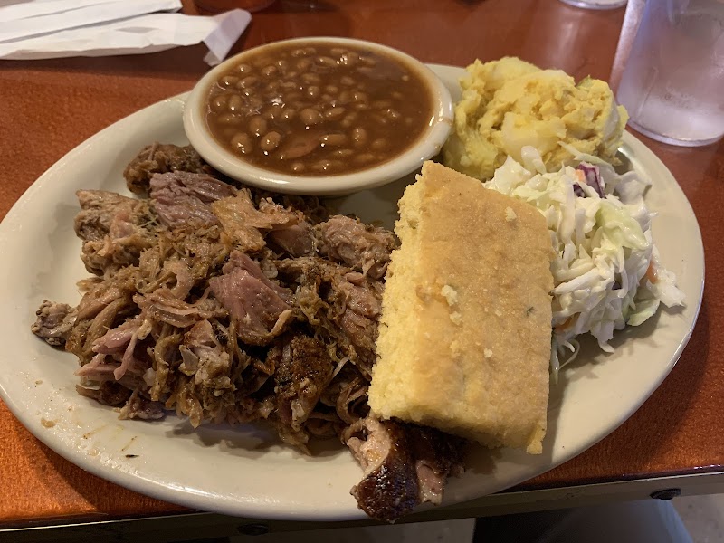 Plate at Acadia National Park with pulled pork, baked beans, cornbread, coleslaw, and potato salad.