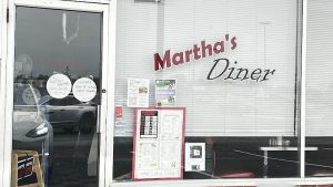 Diner storefront exterior with large blinds and signage in Acadia National Park, showing a casual roadside eatery.
