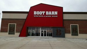 Western wear gift shop facade at Yellowstone National Park, showcasing a bold red entrance.