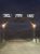 Entrance gate to Circle View Ranch at Badlands National Park, illuminated at night with a wooden arch and signs.