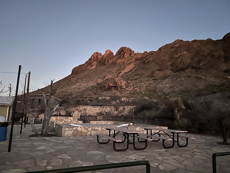 Terlingua Ranch Lodge patio at Big Bend National Park with rocky desert mountains rising beyond the stone seating area.