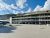 Lodge-style hotel building in Yellowstone National Park with mountain backdrop and blue sky.