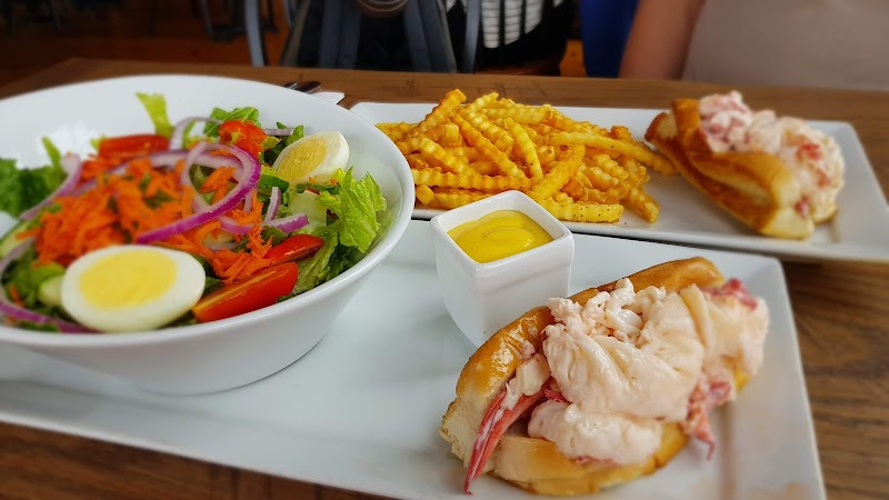 Lobster roll with fries and salad served at a restaurant near Acadia National Park in Maine.