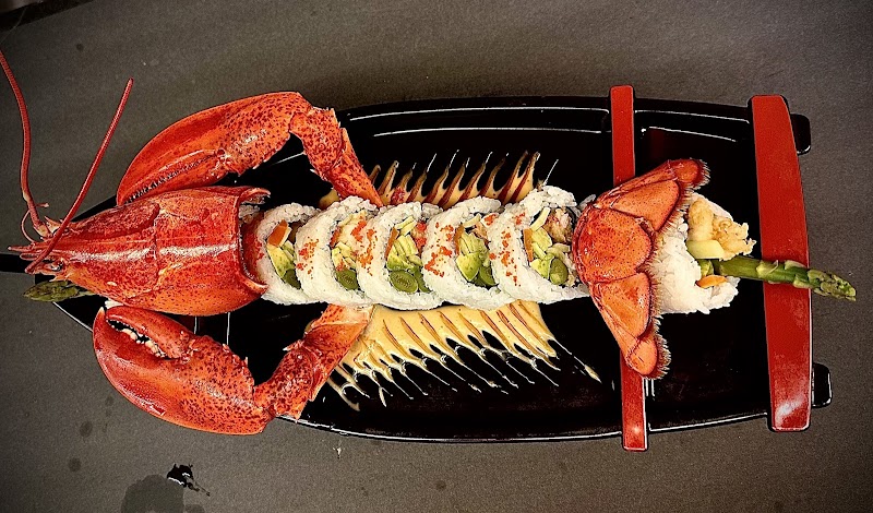 Lobster-tail sushi roll plated on a sleek black dish in Acadia National Park.