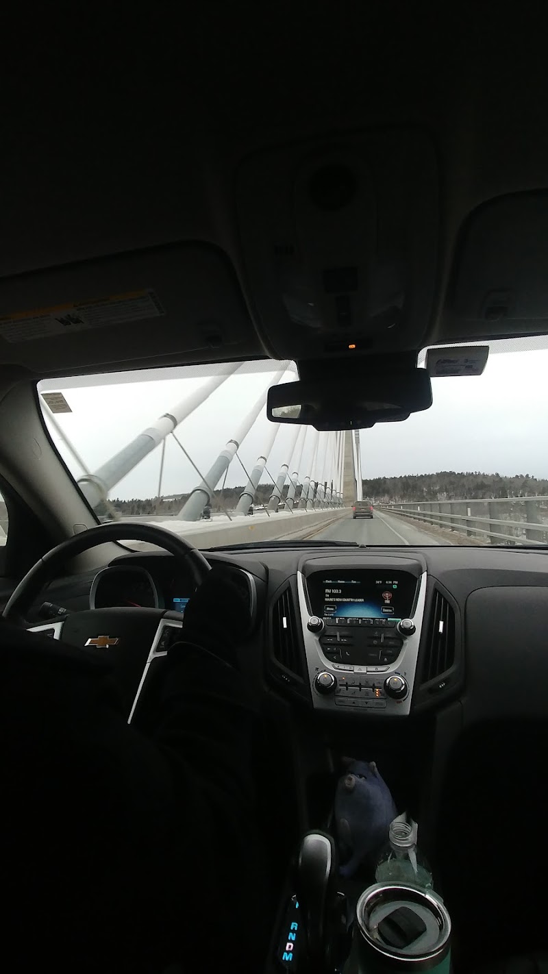 Vehicle view driving toward Stockton Springs bridge within Acadia National Park, Maine.