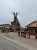 Giant wooden elk sculpture and rustic storefronts in Wall, South Dakota near Badlands National Park.