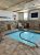 Indoor pool room with stone walls and a wooden ceiling at Big Bend National Park lodging.