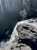 Moose Falls waterfall drops from rugged rock ledges into a rocky pool, Yellowstone National Park.