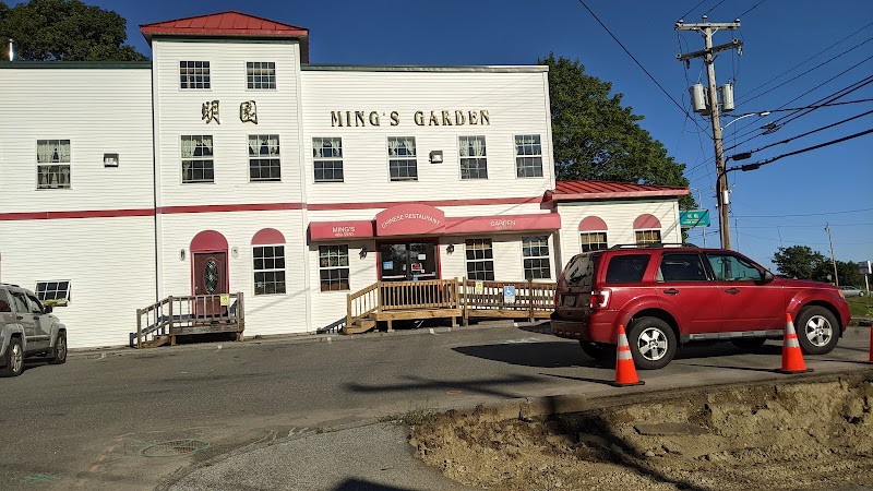 White two-story restaurant building with a red roof and wooden porch in Acadia National Park.