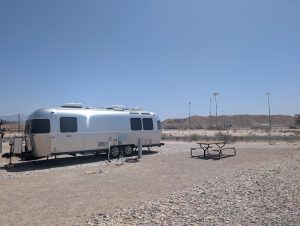 Around The Bend RV Park in Big Bend National Park shows a silver Airstream trailer at a desert campground with distant mesas.