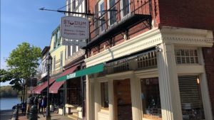 Stadium storefront on Main Street in Bar Harbor, Acadia National Park, offering lobster rolls and coffee.