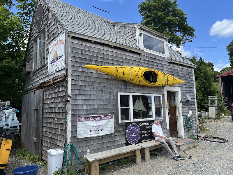 Rustic wooden gift shop in Bar Harbor with a bright yellow kayak mounted above the window, near Acadia National Park.