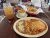 Enchilada dinner plate with rice and beans at a dining area inside Big Bend National Park, served with salsa and a mason jar drink.