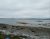 Brooklin shoreline along Acadia National Park presents a rocky coastal scene under a gray overcast sky.